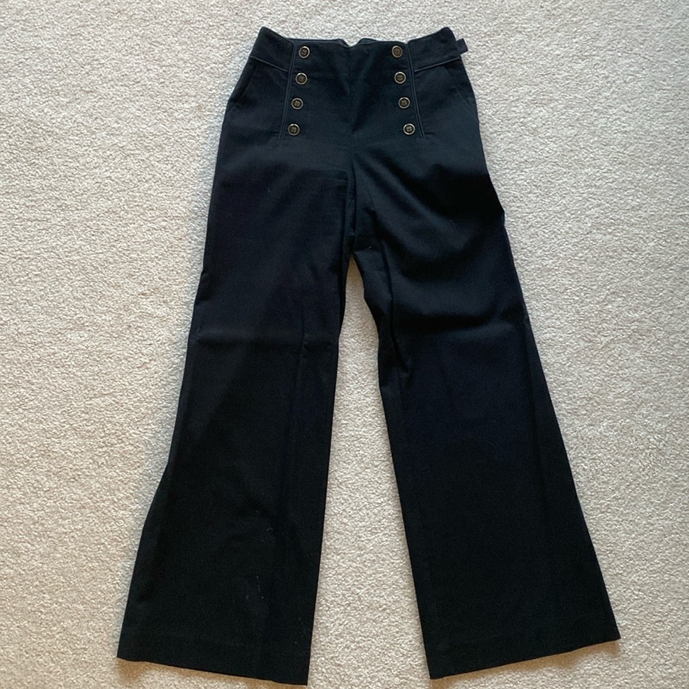 High waisted, lightly flared black pants with button accents from Elevenses